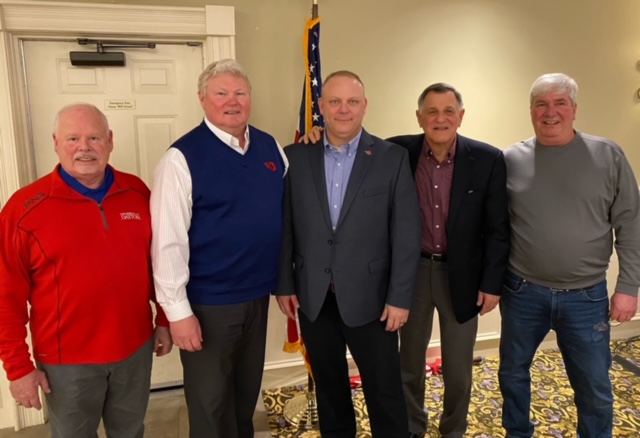 A group of men standing next to each other.